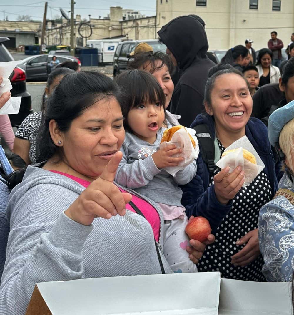Hands serving food, illustrating practical service and care.